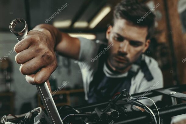 Meccanico che esegue il tagliando su una moto in officina